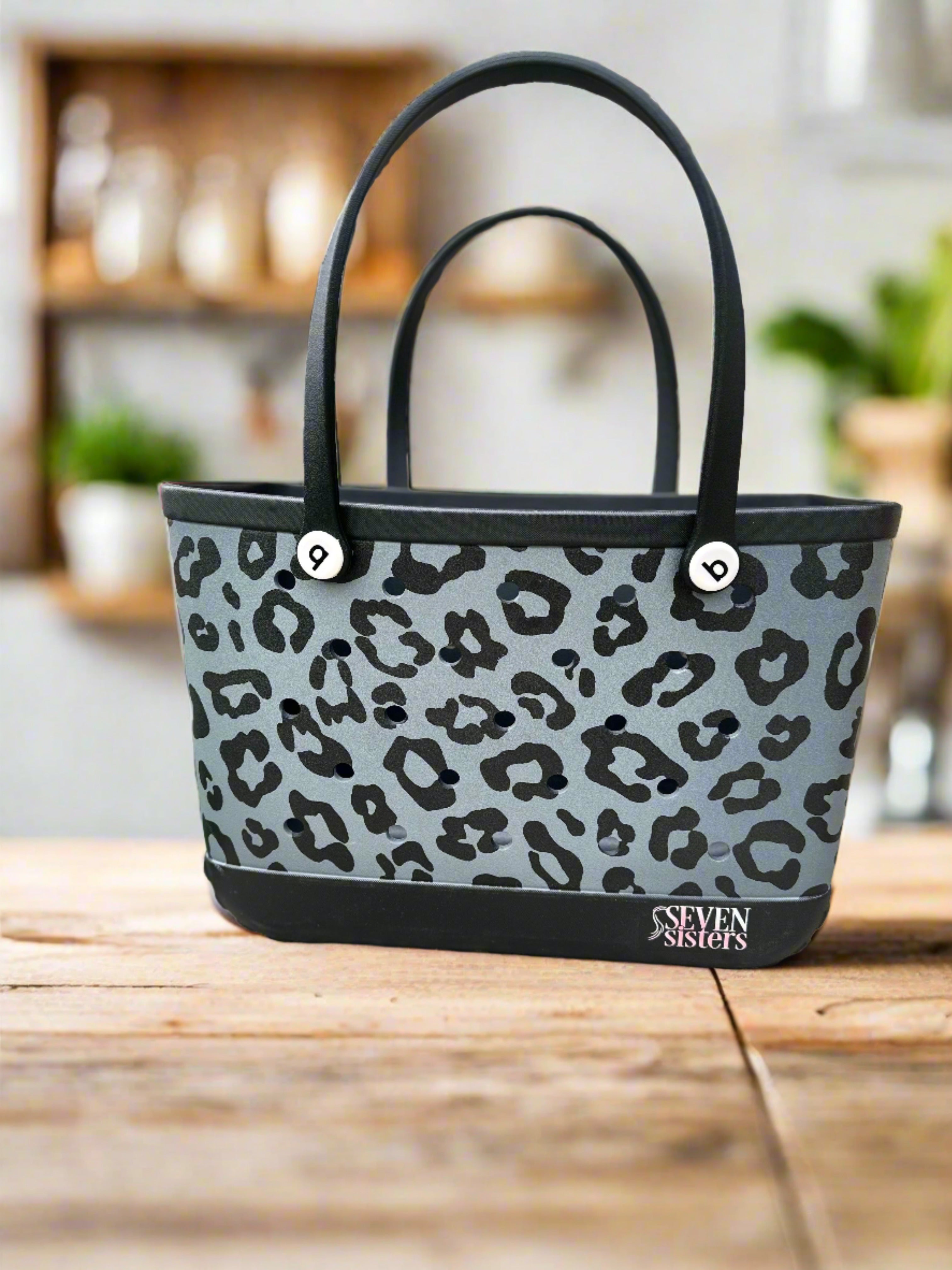 Seven Sisters - Stay stylish and organized with our Black Leopard Waterproof Silicone Tote. Perfect for the beach, pool, or any on-the-go activity. Durable and versatile, this tote is a must-have accessory for all your essentials. Order yours today!