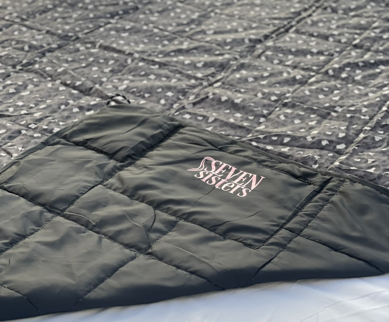 Introducing the Seven Sisters Sammie Snug Weighted Blanket - the perfect companion for outdoor activities like camping, picnics, and kids' sporting events. This waterproof and weighted blanket provides comfort and relaxation wherever you go. With its versatile design, it can also be used as a regular blanket for everyday use. Stay cozy and snug with the Seven Sisters Sammie Snug Weighted Blanket.